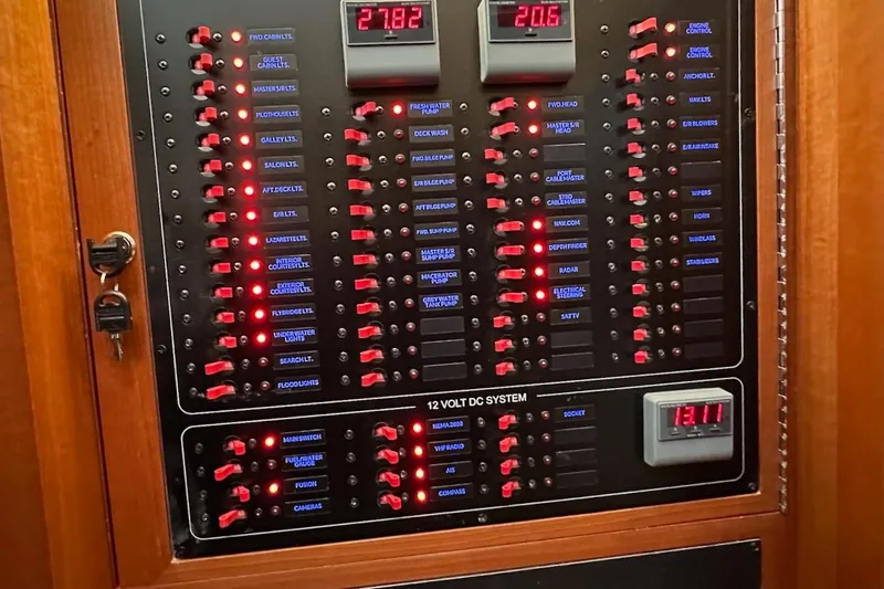 Slide: The Image of Electrical control panel of a 2024 Northwest 55 boat, featuring switches and voltage displays. - 51
