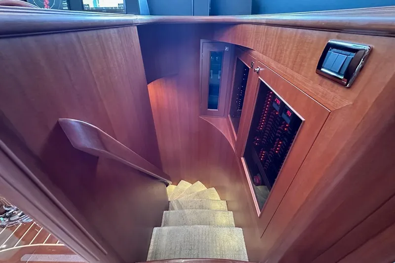 Slide: The Image of Staircase in 2024 Northwest 55 yacht with wooden paneling and control panels. - 53