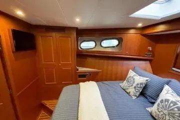 Slide: The Image of Luxurious cabin interior of 2024 Northwest 55 yacht with cozy bedding and elegant wood finish. - 59