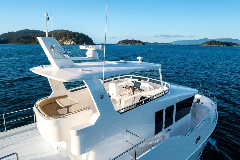 Slide: The Image of Luxurious 2024 Northwest 55 yacht cruising in scenic ocean waters. - 6