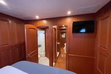 Slide: The Image of Luxurious Northwest 55 yacht interior, 2024 model, featuring wood paneling and modern amenities. - 60