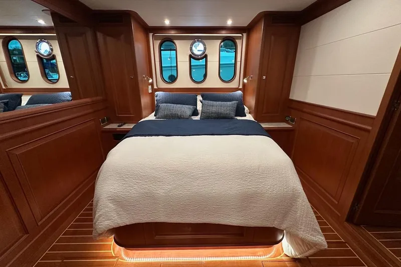 Slide: The Image of Luxurious cabin interior of 2024 Northwest 55 yacht with elegant wood paneling and cozy bedding. - 66