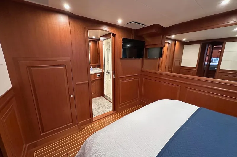Slide: The Image of Luxurious cabin interior of 2024 Northwest 55 yacht with wood paneling and ensuite bathroom. - 69