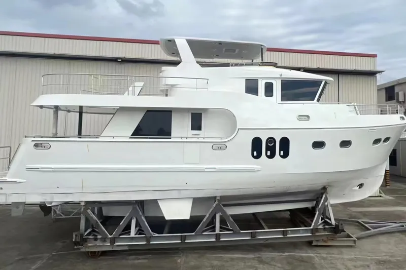 Slide: The Image of 2024 Northwest 55 yacht on display in a shipyard, showcasing sleek design and modern features. - 7