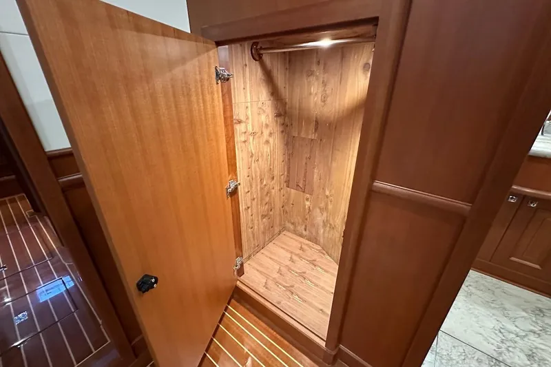 Slide: The Image of Wooden closet interior in a 2024 Northwest 55 yacht, featuring elegant wood paneling. - 70
