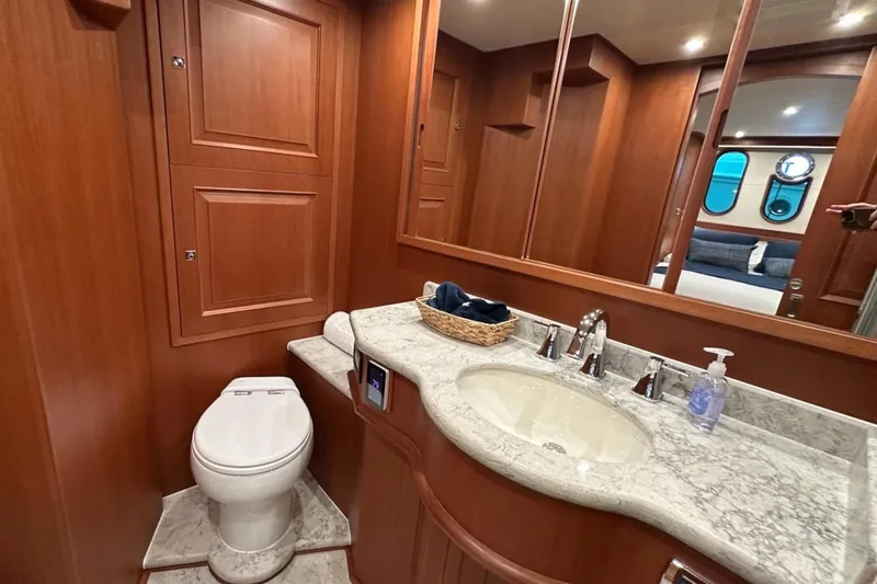 Slide: The Image of Luxurious bathroom in 2024 Northwest 55 yacht with marble countertop and wooden cabinetry. - 73