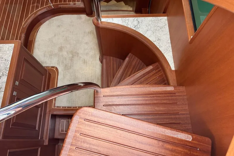 Slide: The Image of Elegant wooden staircase on 2024 Northwest 55 yacht, featuring polished handrails and marble accents. - 75