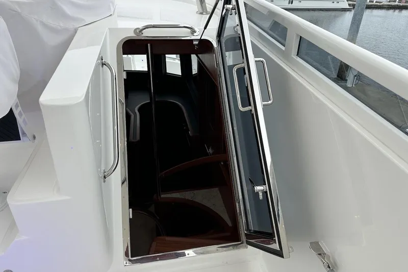 Slide: The Image of Open hatch on 2024 Northwest 55 yacht, showing interior stairs and sleek design. - 76