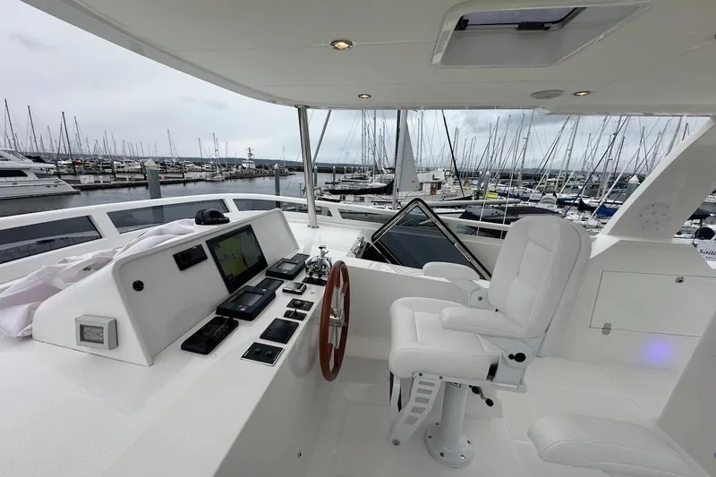 Slide: The Image of Luxurious 2024 Northwest 55 yacht helm with marina view, featuring advanced navigation equipment. - 80