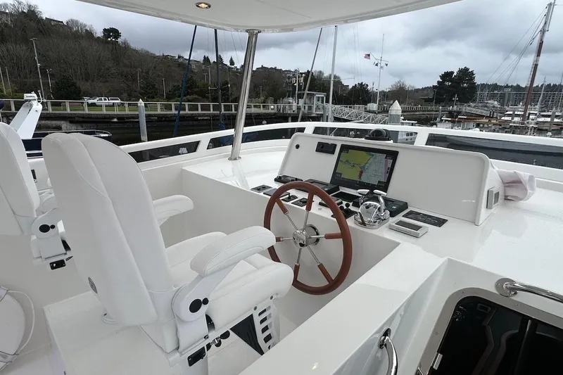 Slide: The Image of Modern helm of 2024 Northwest 55 yacht with navigation system and white seating. - 81