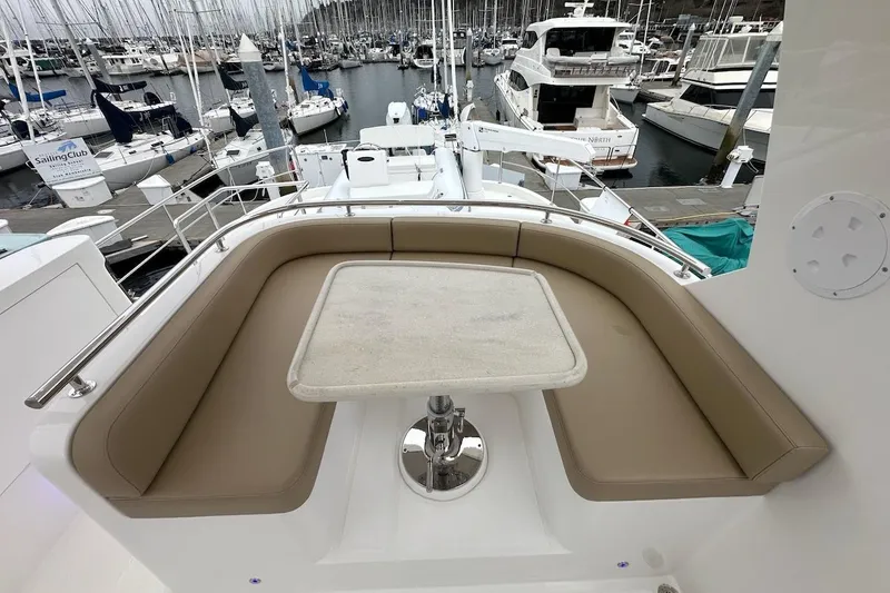 Slide: The Image of Luxury seating area on 2024 Northwest 55 yacht, docked at marina. - 84