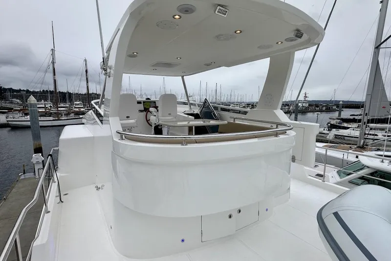 Slide: The Image of Luxury Northwest 55 yacht, 2024 model, docked at marina with sleek design and spacious deck. - 85