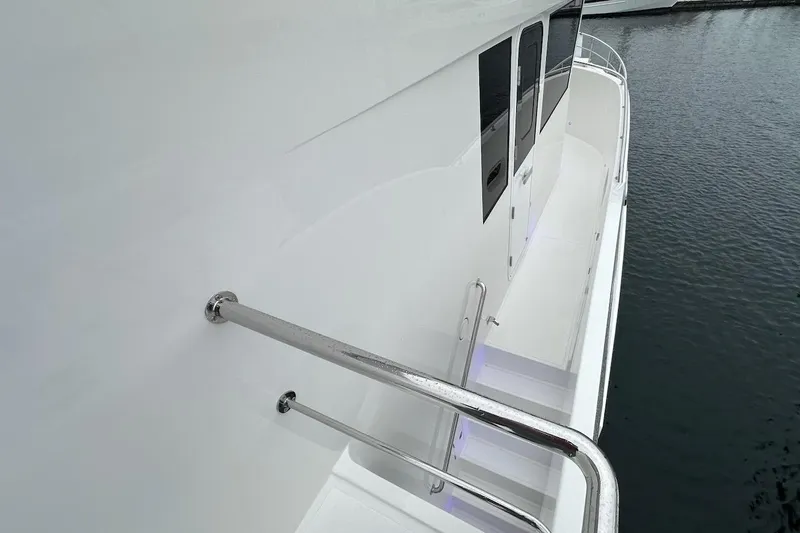 Slide: The Image of Side view of 2024 Northwest 55 yacht with sleek white exterior and stainless steel railings. - 86