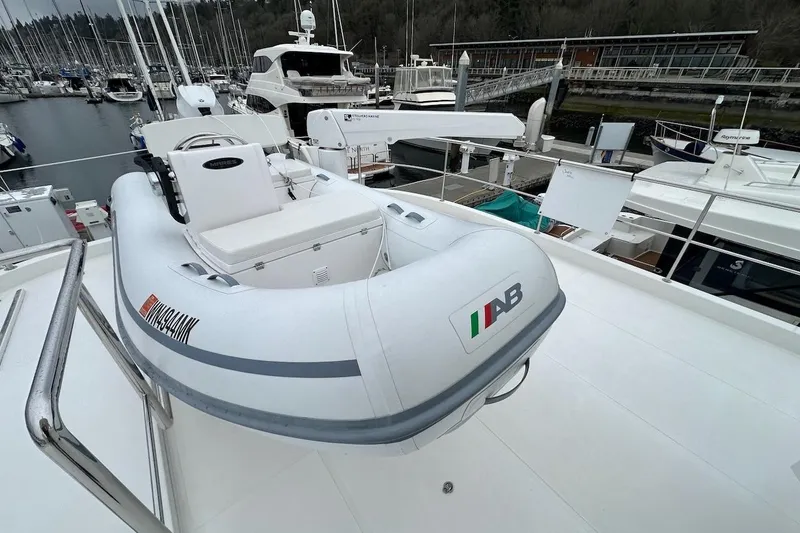 Slide: The Image of Inflatable boat on Northwest 55 yacht, 2024 model, docked at marina. - 87