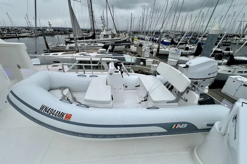 Slide: The Image of Inflatable boat docked at marina, Northwest 55 model, 2024, with overcast sky. - 89
