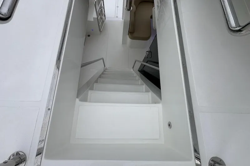 Slide: The Image of Staircase on 2024 Northwest 55 yacht, featuring sleek white design and modern handrails. - 91
