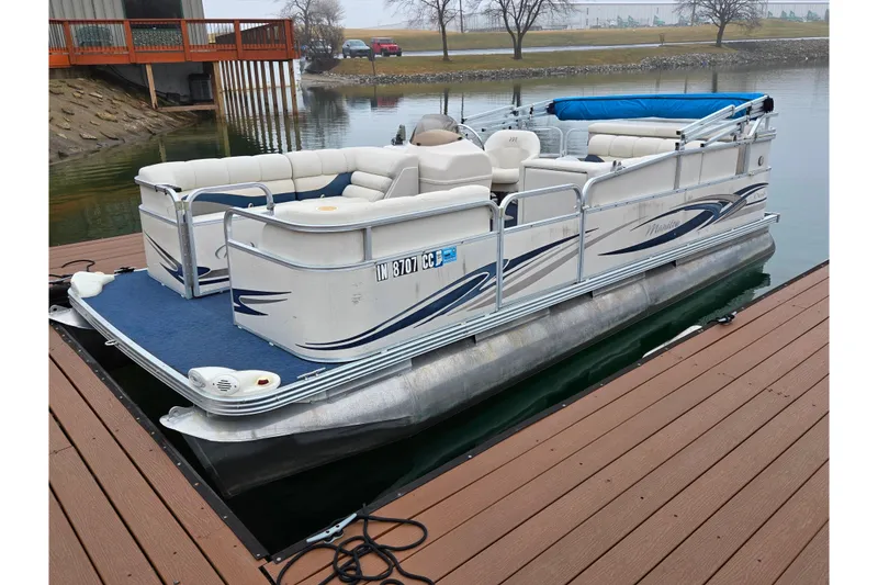 The Image of 2005 Manitou 20 Oasis pontoon boat docked on a calm lake. - 0