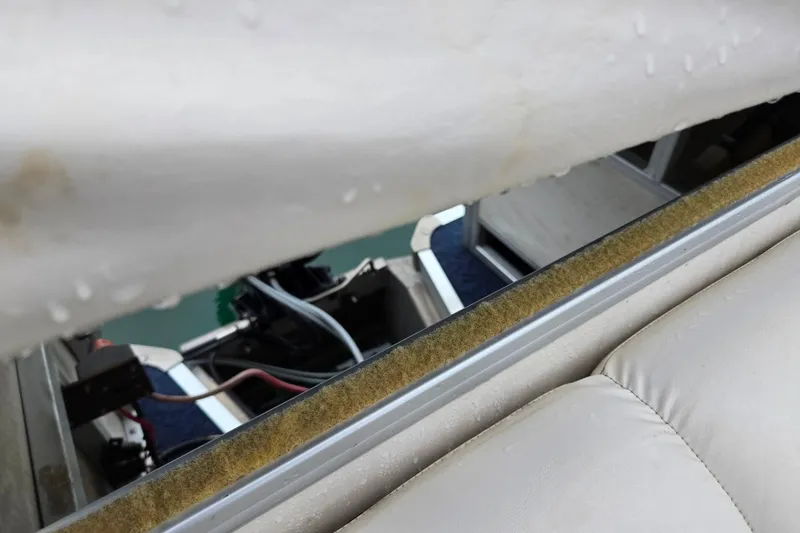 Slide: The Image of 2005 Manitou 20 Oasis boat interior with visible seating and railing details. - 16