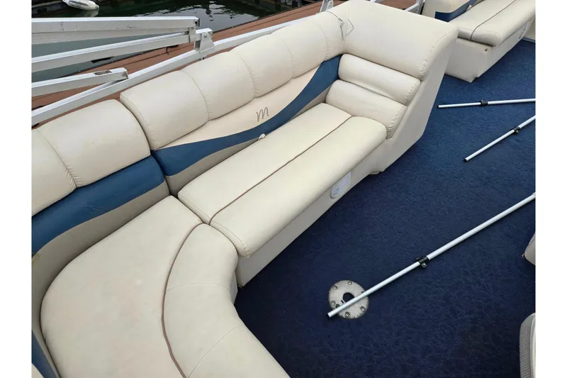 Slide: The Image of 2005 Manitou 20 Oasis boat interior with beige and blue seating. - 17