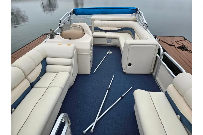 Slide: The Image of 2005 Manitou 20 Oasis pontoon boat with spacious seating and blue carpet interior. - 8