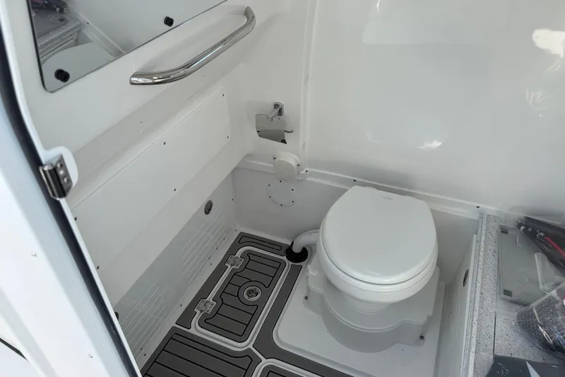 Slide: The Image of 2026 Tidewater 3100 Carolina Bay boat interior with modern marine toilet and sleek design. - 11
