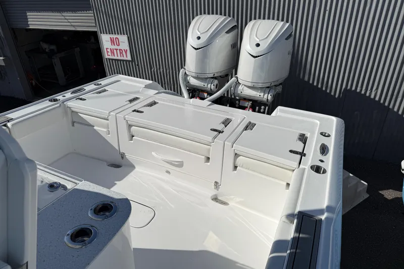 Slide: The Image of 2026 Tidewater 3100 Carolina Bay boat with dual outboard engines, docked near a "No Entry" sign. - 12