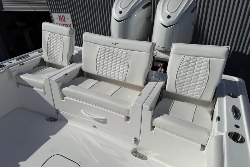 Slide: The Image of 2026 Tidewater 3100 Carolina Bay boat seating with luxurious white upholstery and dual engines. - 13
