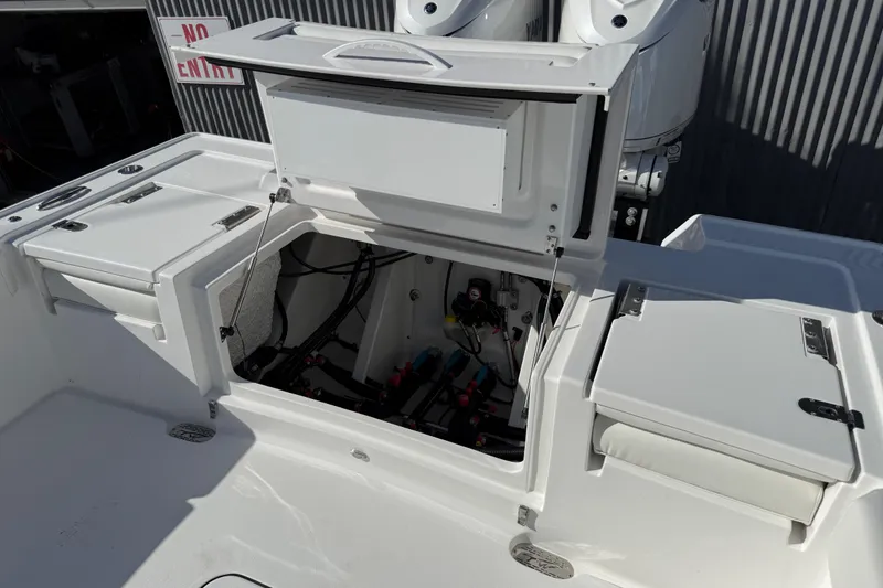 Slide: The Image of 2026 Tidewater 3100 Carolina Bay boat interior with open storage compartments and visible wiring. - 14