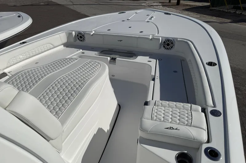 Slide: The Image of 2026 Tidewater 3100 Carolina Bay boat interior with white quilted seating and modern design. - 8