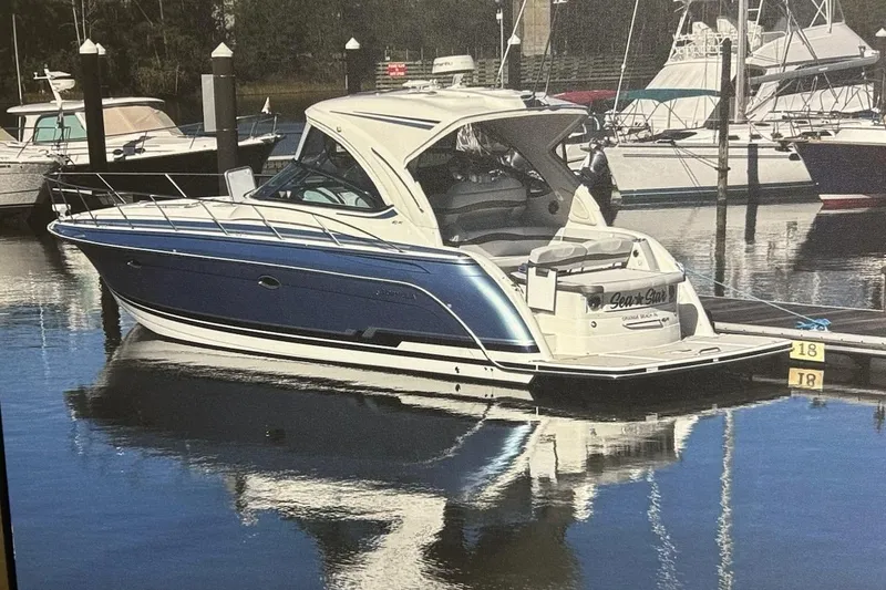 The Image of 2018 Formula 40 Performance Cruiser docked in a marina, reflecting on calm water. - 0