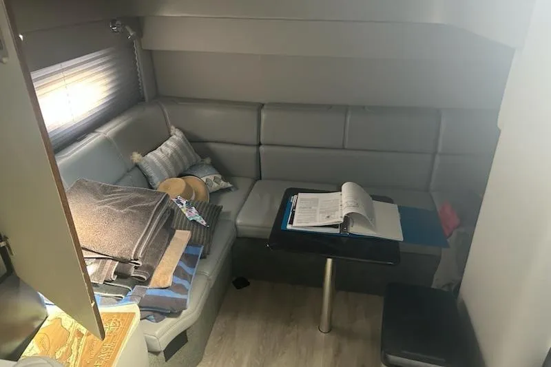 Slide: The Image of 2018 Formula 40 Performance Cruiser interior with gray seating, table, and nautical decor. - 15