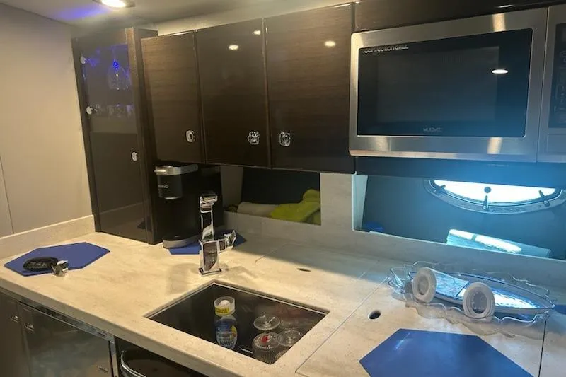 Slide: The Image of 2018 Formula 40 Performance Cruiser kitchen with modern appliances and sleek cabinetry. - 21