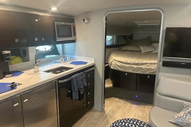 Slide: The Image of Interior of a 2018 Formula 40 Performance Cruiser with modern kitchen and cozy sleeping area. - 25