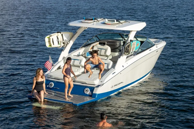 Slide: The Image of 2026 Regal LS9 boat on calm water near a bridge, surrounded by trees. - 1