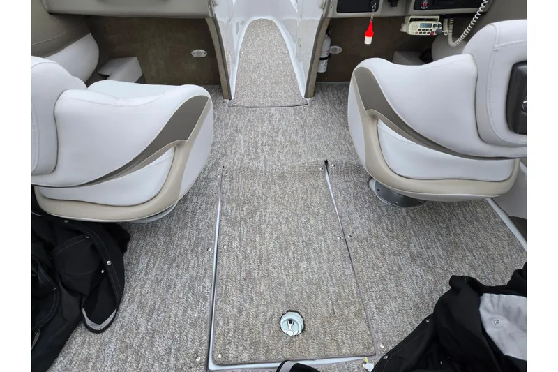 Slide: The Image of Interior of 2012 Crownline 235 SS boat with beige seating and carpeted flooring. - 11