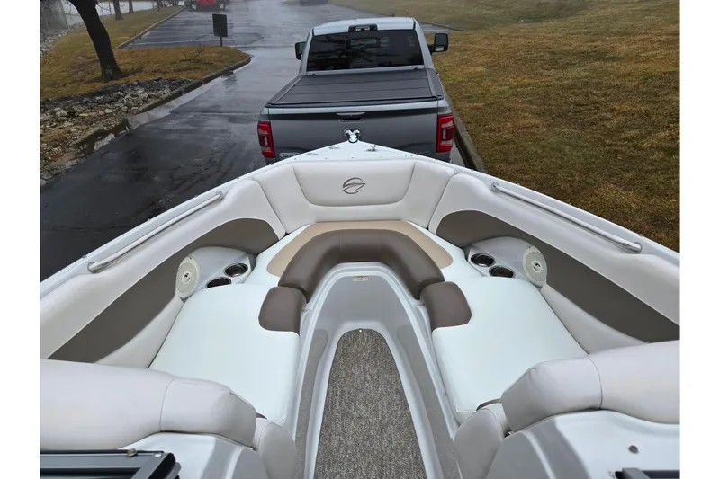 Slide: The Image of 2012 Crownline 235 SS boat interior with seating, parked on a trailer. - 19