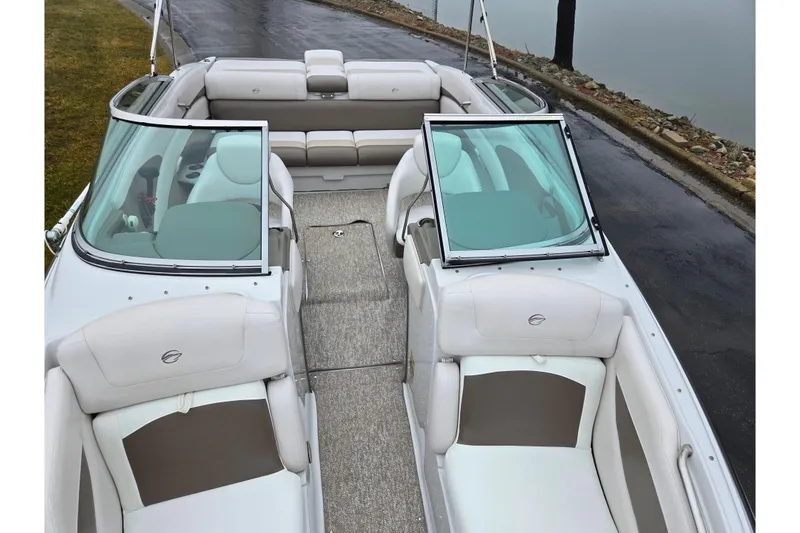 Slide: The Image of 2012 Crownline 235 SS boat interior with beige seating and open windshield. - 22