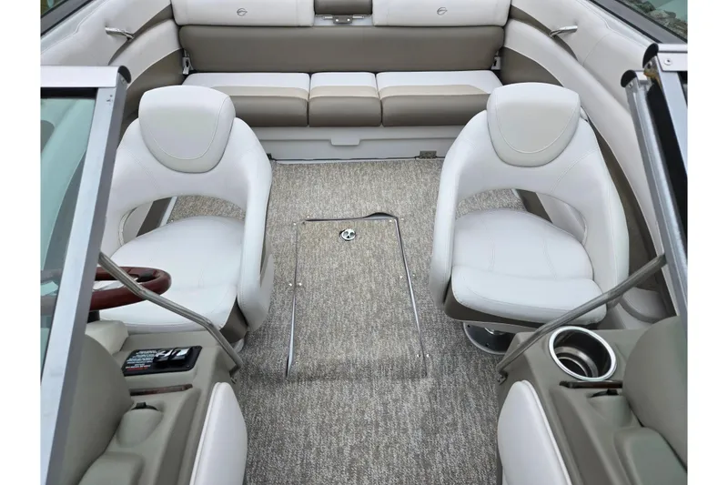 Slide: The Image of Interior of 2012 Crownline 235 SS boat with white seating and carpeted floor. - 23