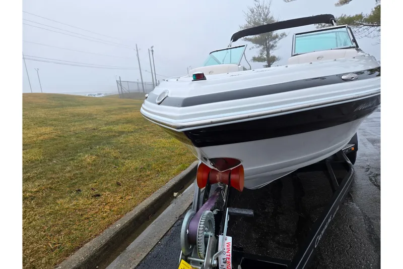 Slide: The Image of 2012 Crownline 235 SS boat on trailer in foggy outdoor setting. - 6