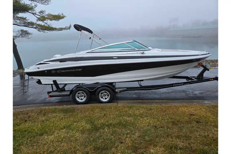 Slide: The Image of 2012 Crownline 235 SS boat on trailer by a foggy lake. - 9