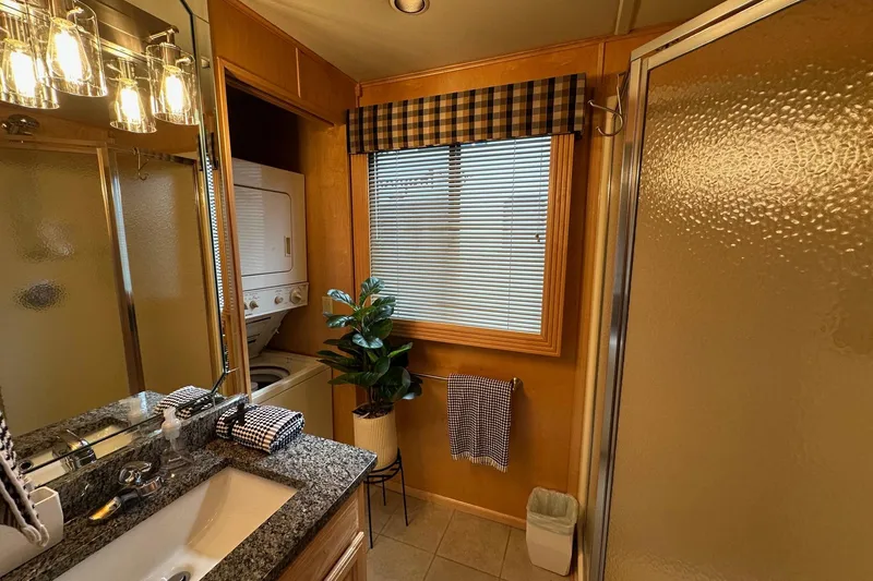 Slide: The Image of Bathroom in 2005 Sumerset 16x68 houseboat with granite countertop, shower, and washer-dryer unit. - 10