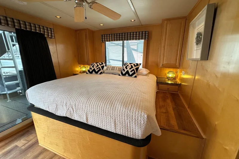 Slide: The Image of Luxurious bedroom interior in a 2005 Sumerset 16x68 houseboat with cozy bedding. - 11