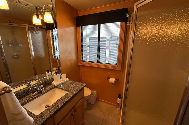 Slide: The Image of Bathroom in 2005 Sumerset 16x68 houseboat with granite countertop and shower. - 13