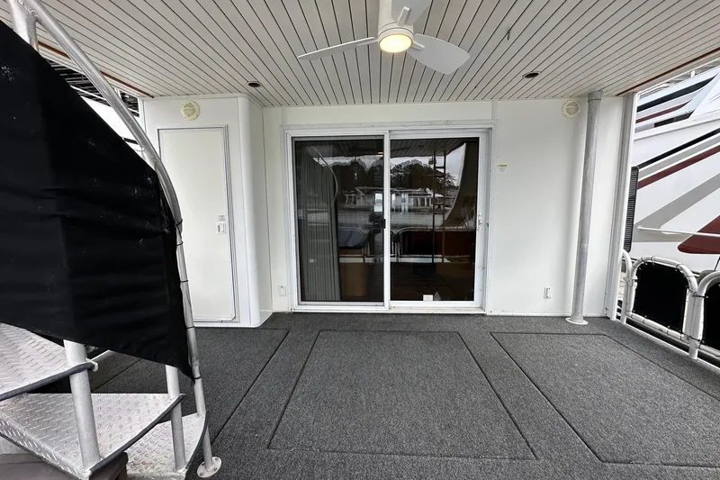 Slide: The Image of 2005 Sumerset 16x68 houseboat deck with sliding glass doors and ceiling fan. - 15