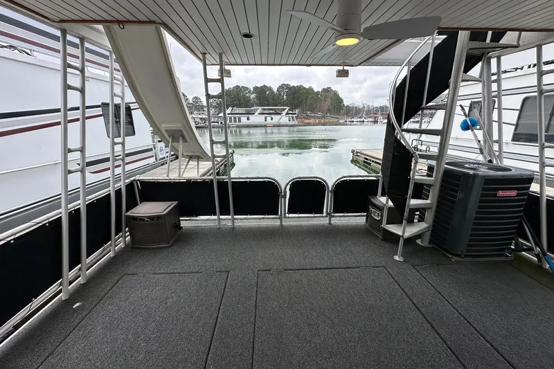 Slide: The Image of 2005 Sumerset 16x68 houseboat deck with spiral staircase and water view. - 16