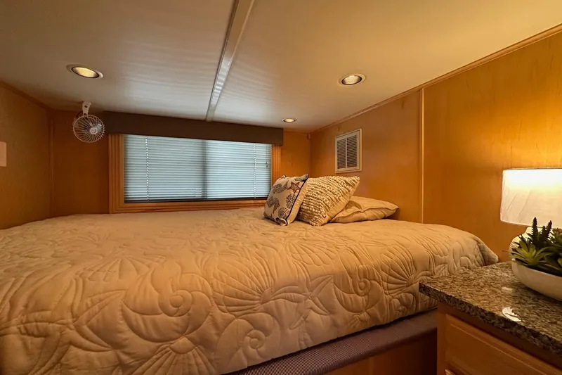 Slide: The Image of Cozy bedroom in 2005 Sumerset 16x68 houseboat with elegant bedding and soft lighting. - 7
