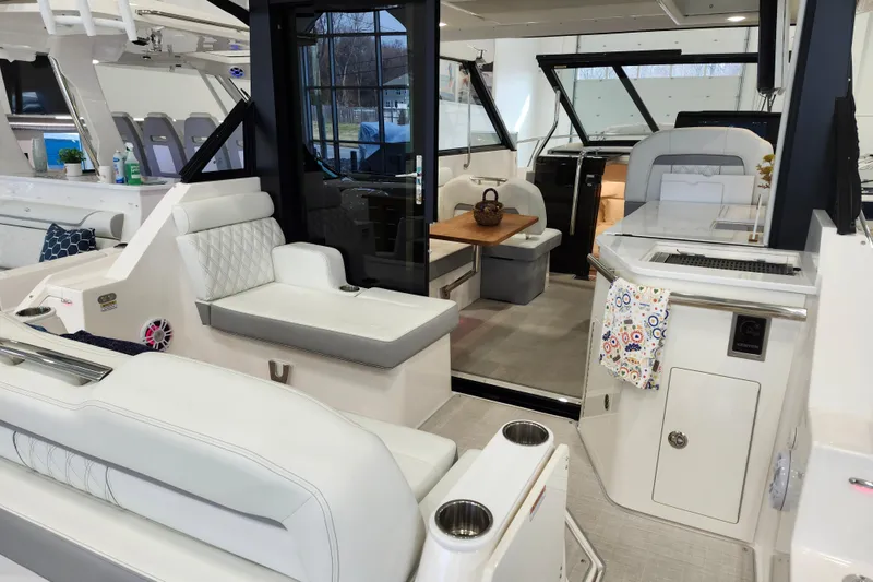 Slide: The Image of 2025 Regal 36 XO yacht interior with modern seating and dining area. - 11