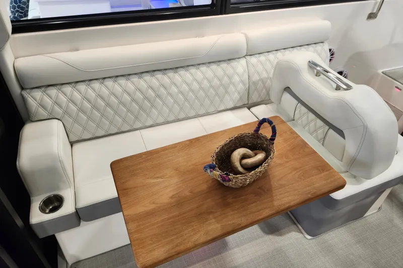 Slide: The Image of Luxurious interior of 2025 Regal 36 XO yacht with elegant seating and wooden table. - 18