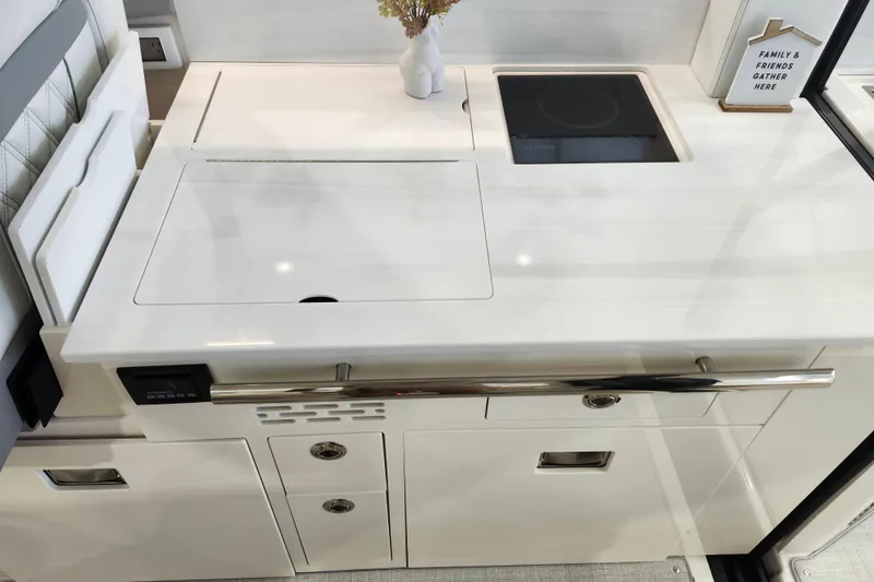 Slide: The Image of Modern kitchen area in 2025 Regal 36 XO yacht, featuring sleek design and induction cooktop. - 21