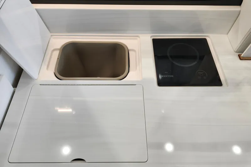 Slide: The Image of Modern kitchen area in 2025 Regal 36 XO boat with sink and Kenyon cooktop. - 24